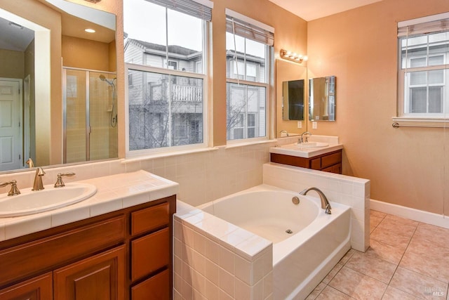 bathroom featuring vanity, a healthy amount of sunlight, separate shower and tub, and tile patterned flooring