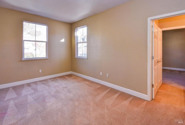 carpeted spare room featuring a healthy amount of sunlight