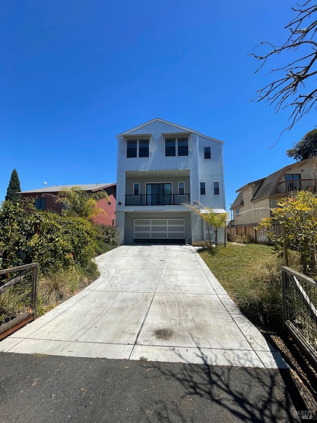 view of front of home with a garage and a balcony