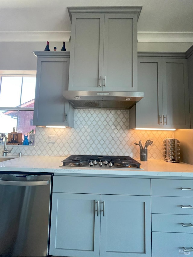 kitchen with decorative backsplash, appliances with stainless steel finishes, sink, and crown molding