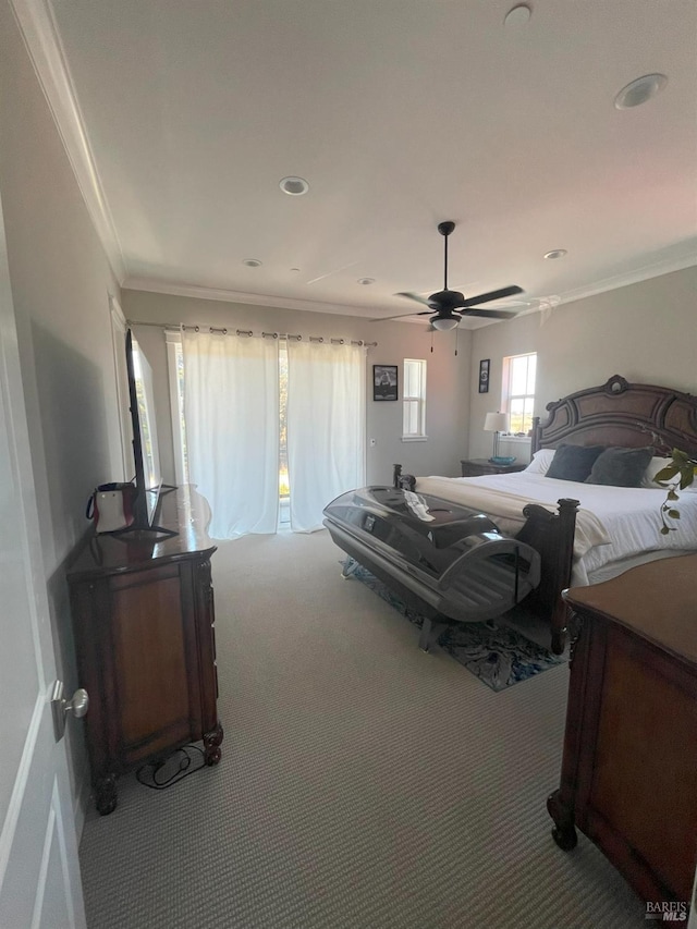carpeted bedroom featuring ceiling fan and crown molding