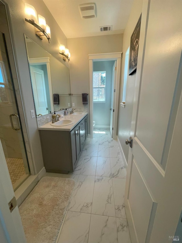 bathroom with a shower with shower door, toilet, and vanity