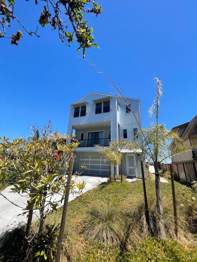 view of front of property featuring a balcony and a garage