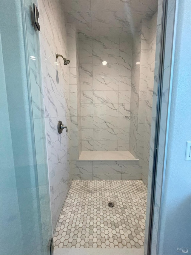 bathroom with tiled shower