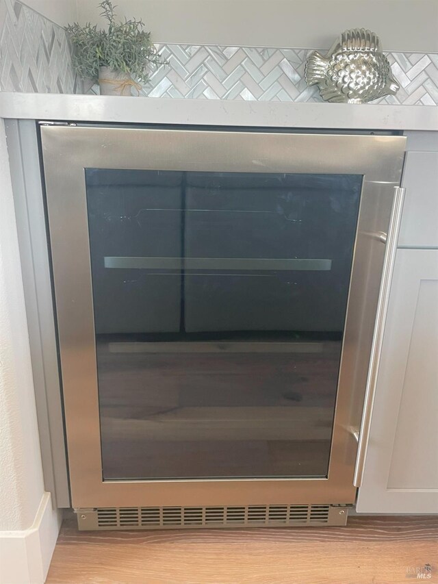 room details with wine cooler and light hardwood / wood-style flooring