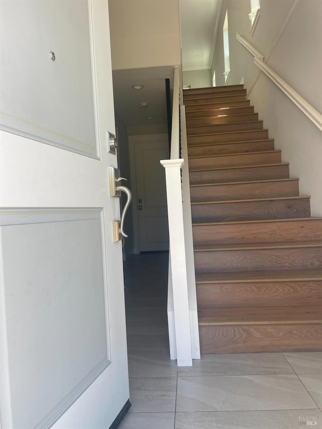 staircase with tile patterned floors