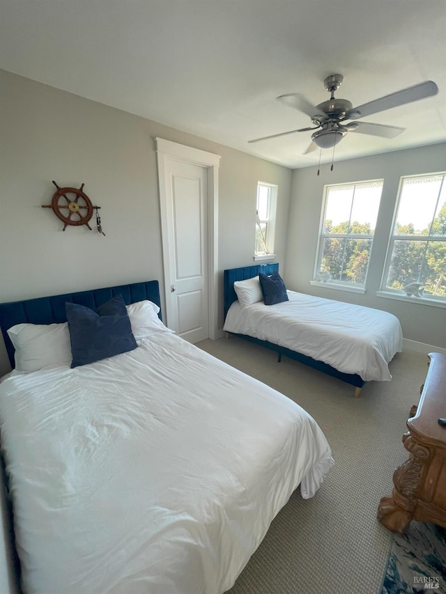 bedroom with ceiling fan and carpet