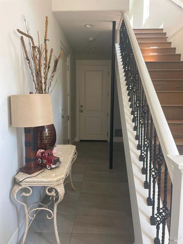 stairway featuring tile patterned floors