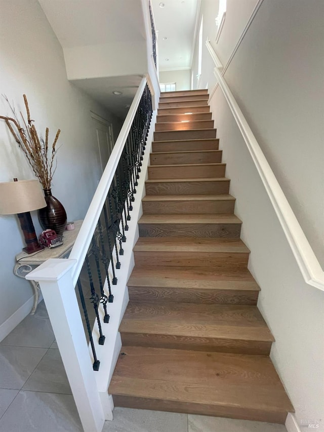 staircase featuring tile patterned floors