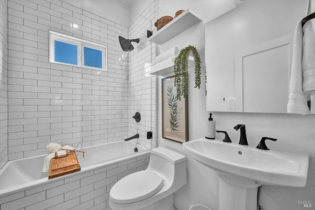 full bathroom with toilet, tiled shower / bath combo, and sink