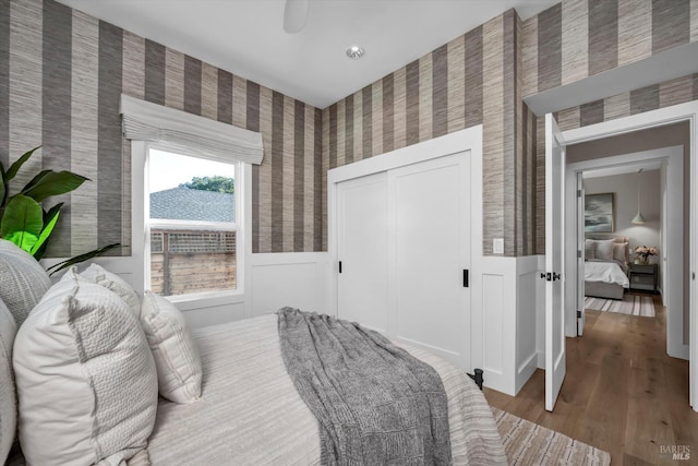 bedroom with a closet and hardwood / wood-style flooring