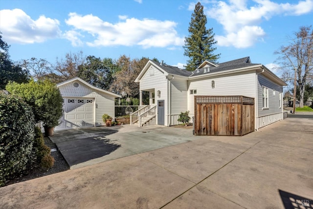 view of front of house featuring a garage and an outdoor structure