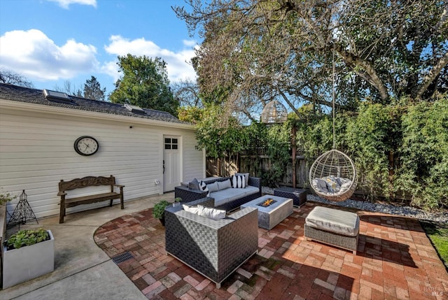 view of patio with an outdoor living space with a fire pit