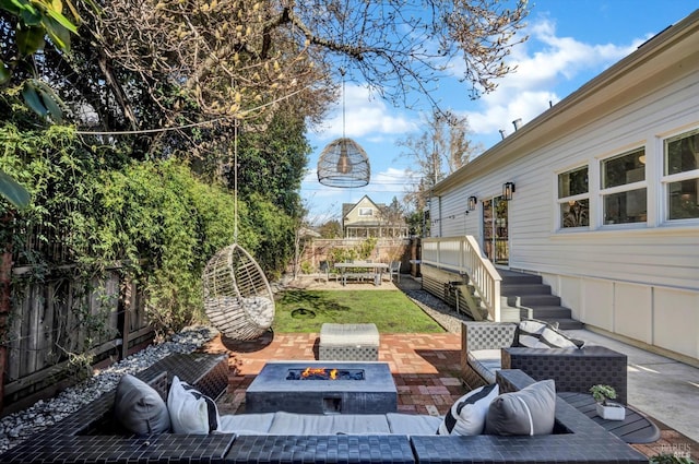 view of patio featuring an outdoor living space with a fire pit