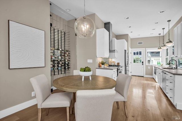 dining room featuring light wood-type flooring and sink