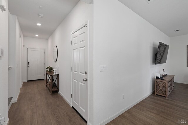 hall with dark hardwood / wood-style flooring