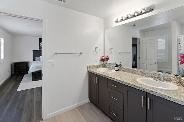 bathroom with vanity, hardwood / wood-style floors, and toilet