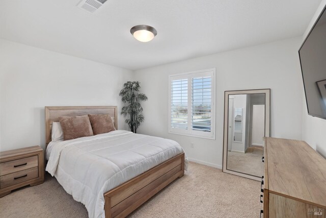 bedroom featuring light colored carpet