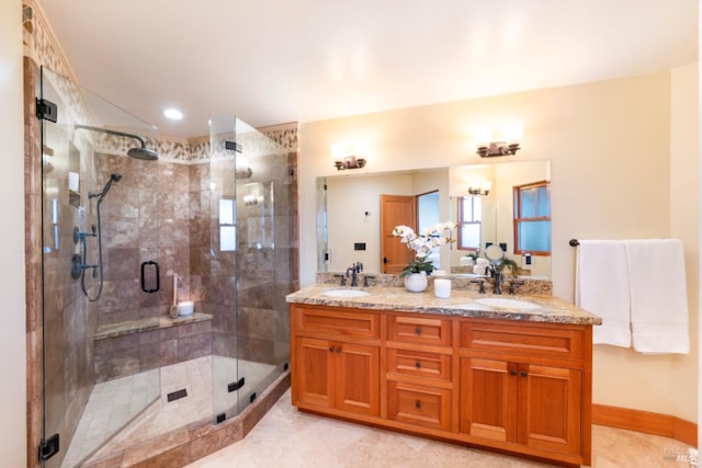 bathroom featuring vanity and a shower with door