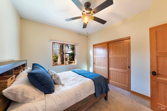 bedroom with ceiling fan and light carpet