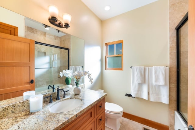 bathroom with vanity, an enclosed shower, and toilet