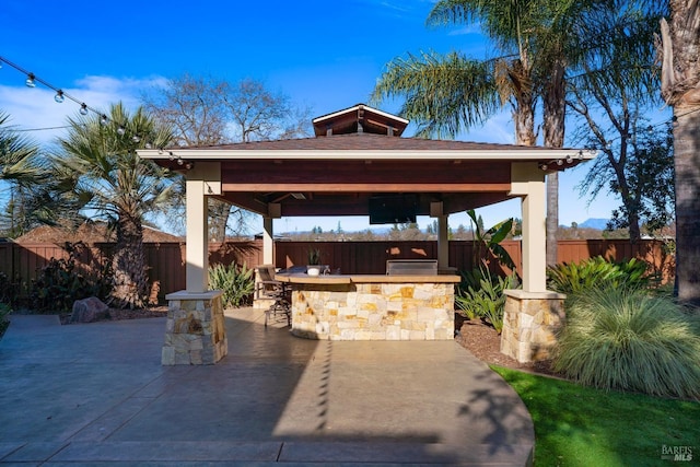 view of patio with a gazebo and exterior bar