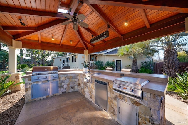 view of patio featuring a gazebo, ceiling fan, a grill, and exterior kitchen