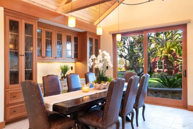 dining room with vaulted ceiling with beams and wood ceiling