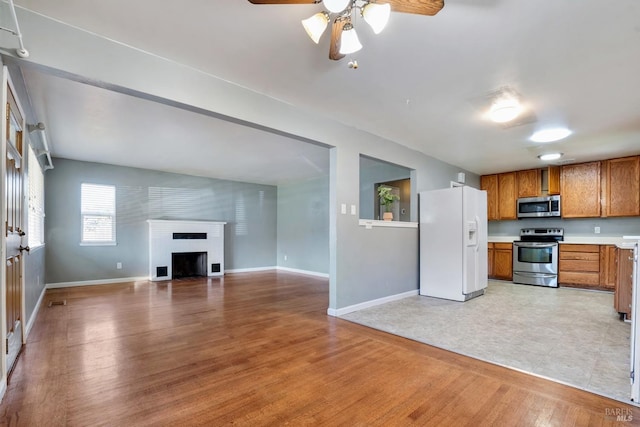 kitchen featuring light hardwood / wood-style floors, appliances with stainless steel finishes, and ceiling fan