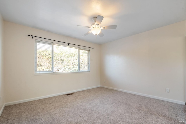 carpeted empty room featuring ceiling fan