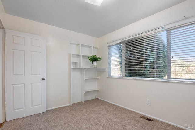 unfurnished bedroom featuring light colored carpet