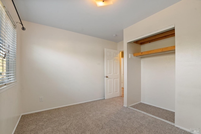 unfurnished bedroom featuring a closet and carpet