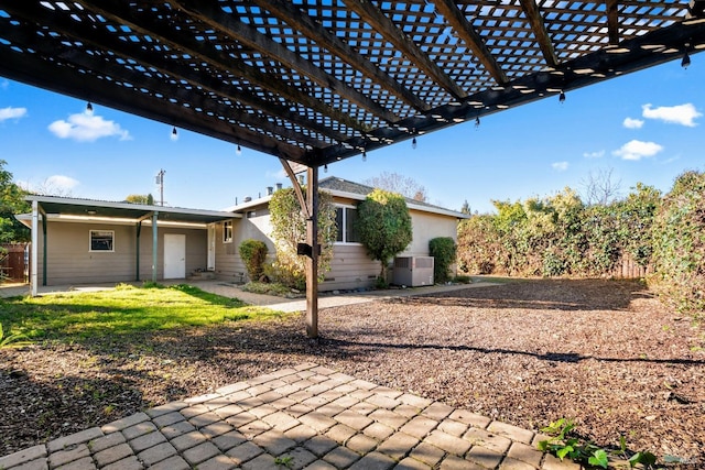 view of patio / terrace with central air condition unit and a pergola