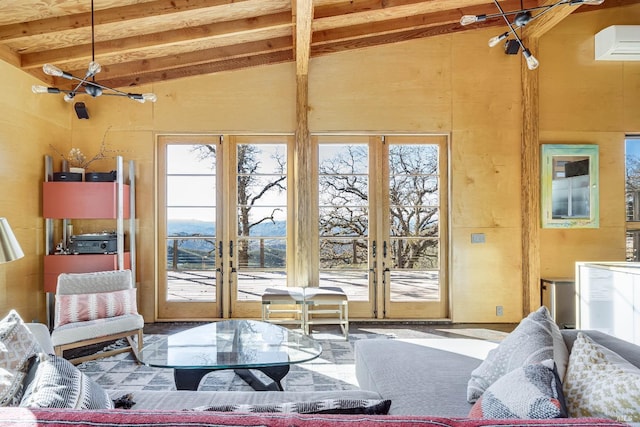 living room featuring beam ceiling, french doors, an AC wall unit, and high vaulted ceiling