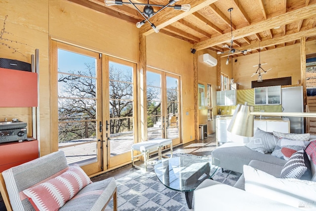 sunroom featuring a wealth of natural light, a wall mounted AC, french doors, and beamed ceiling