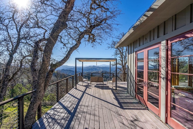 wooden deck with a mountain view and french doors