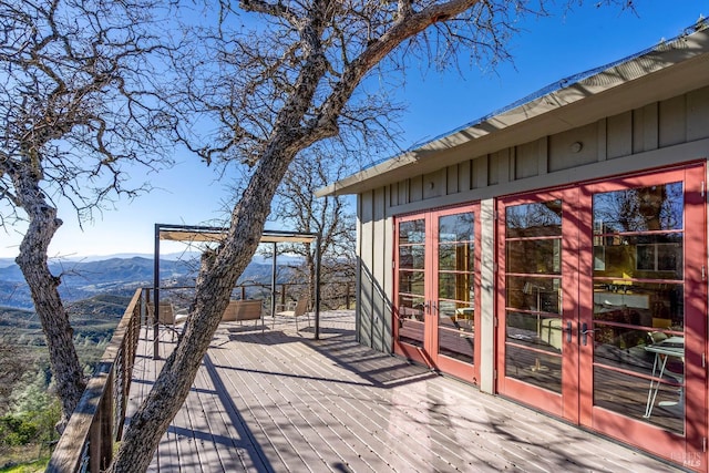 wooden deck with a mountain view and french doors