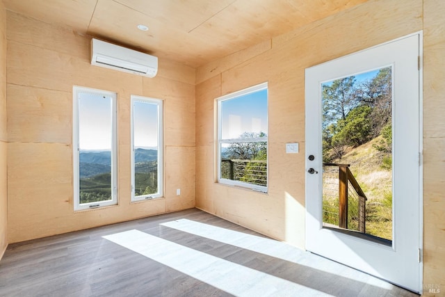 entryway featuring plenty of natural light and a wall mounted air conditioner