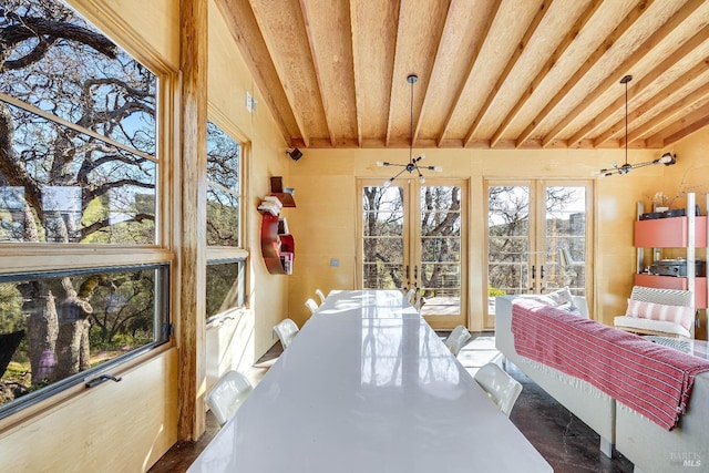 sunroom / solarium with beam ceiling and french doors