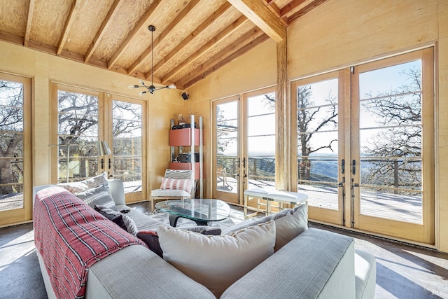 sunroom / solarium with a healthy amount of sunlight, french doors, and vaulted ceiling with beams