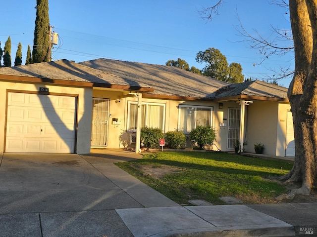 ranch-style home with a garage and a front yard