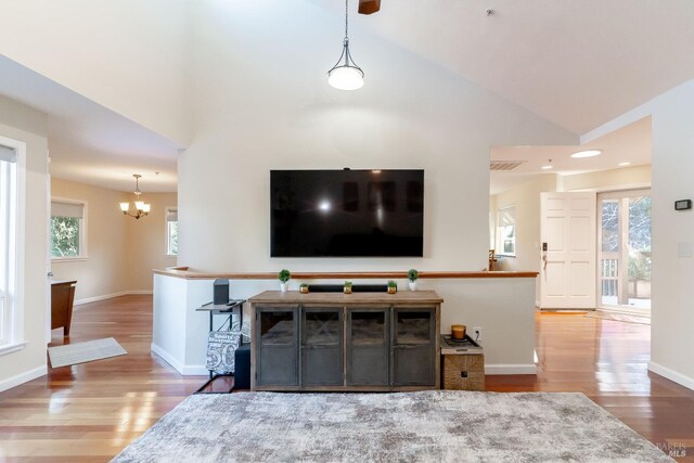 living room with dark hardwood / wood-style flooring, high vaulted ceiling, ceiling fan, and a fireplace