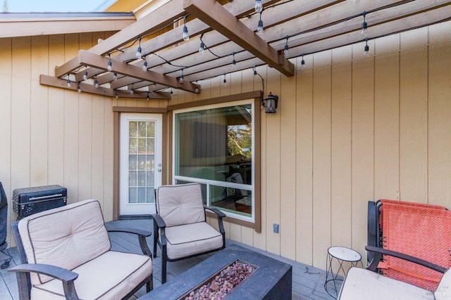 view of patio / terrace with a wooden deck, an outdoor fire pit, and a pergola