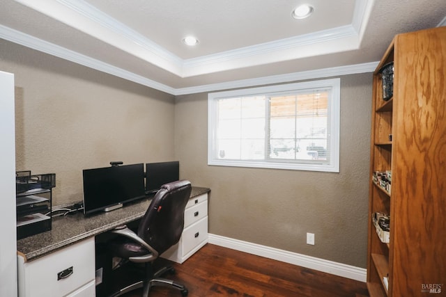 office with ornamental molding, dark wood-type flooring, and a tray ceiling