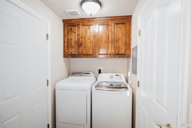 laundry area with cabinets and washer and clothes dryer