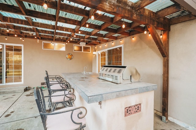 view of patio featuring area for grilling and a bar