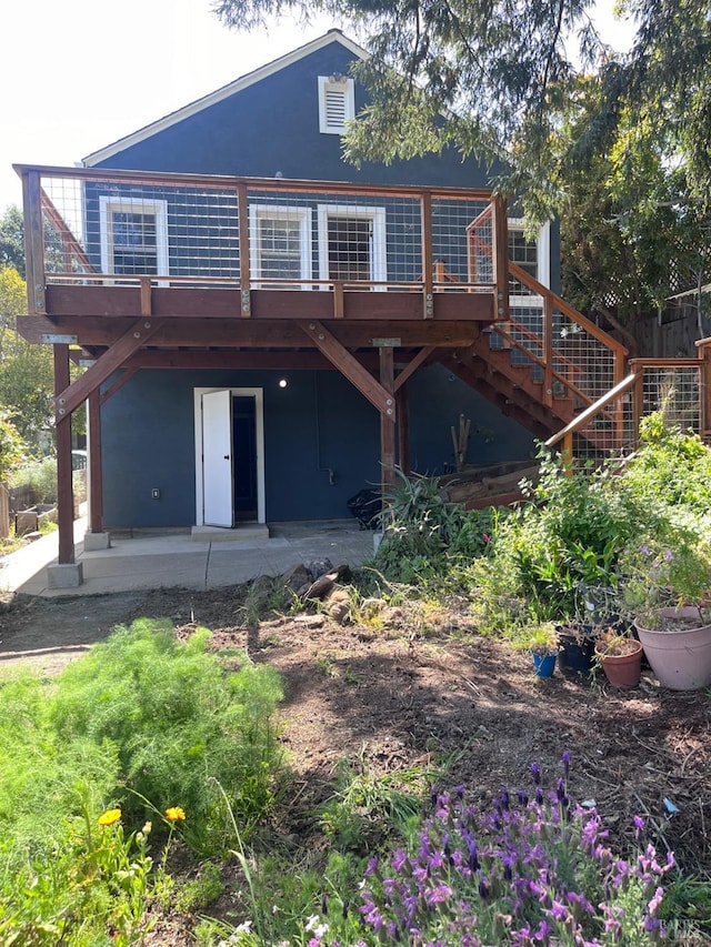 rear view of property with a patio area and a deck