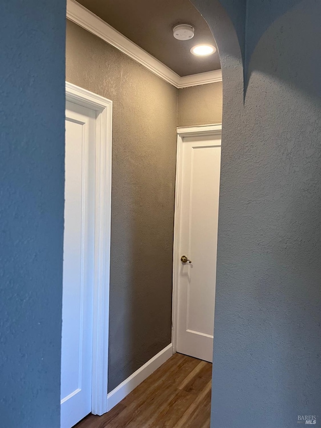 hallway featuring crown molding and wood-type flooring