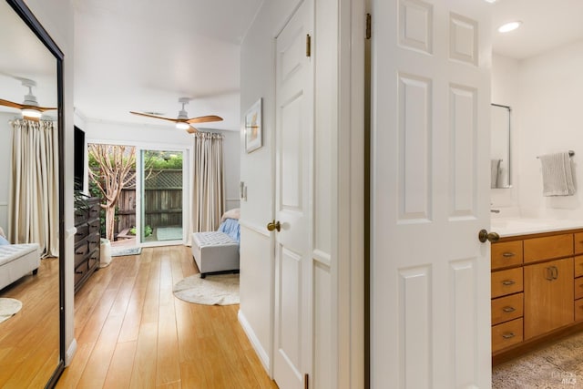 corridor featuring sink and light hardwood / wood-style flooring