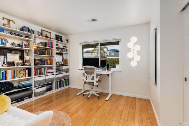 office space with light hardwood / wood-style floors